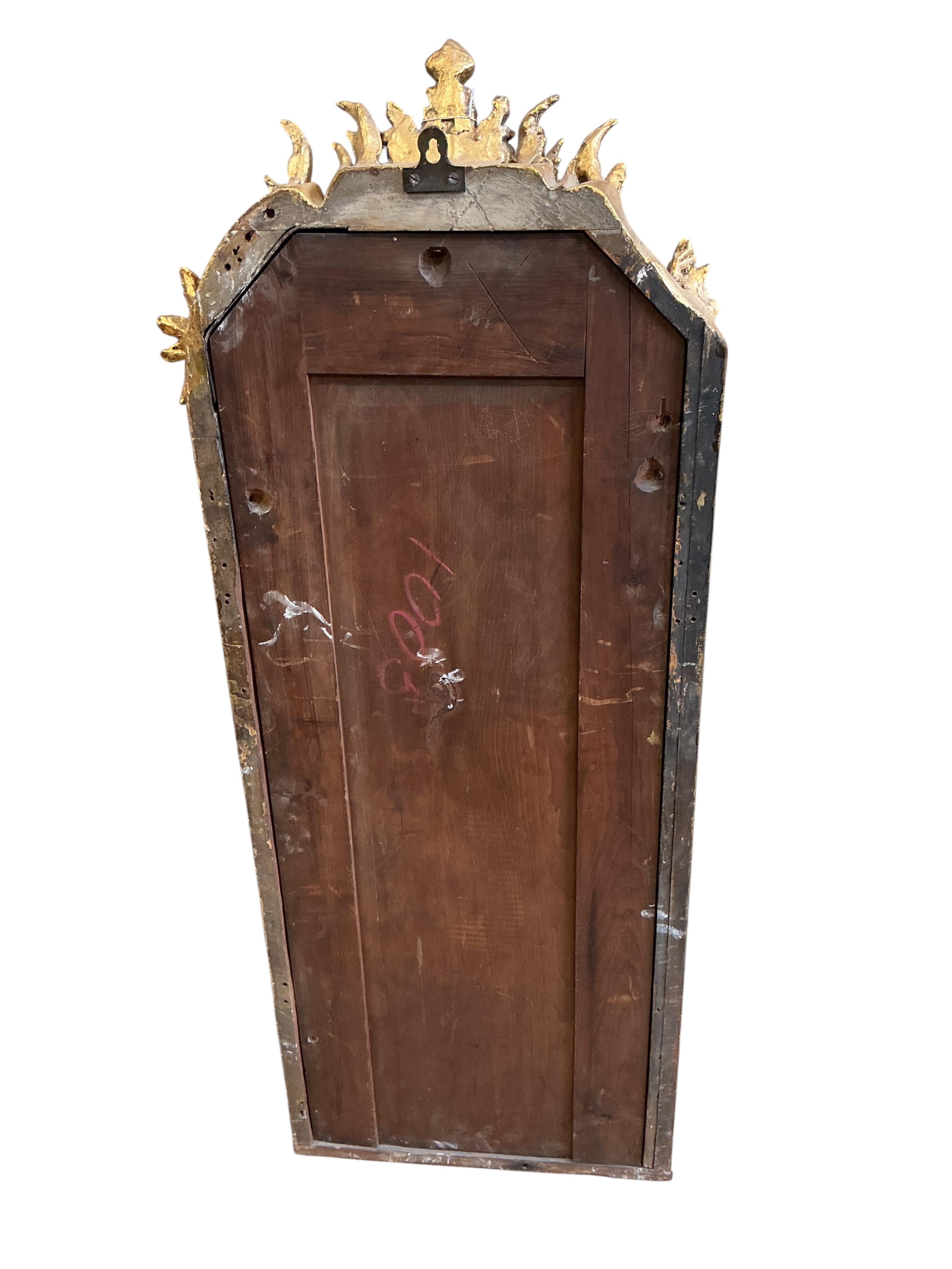 A 19th century carved giltwood and composition wall mirror, re-guilded, width 48cm, height 126cm